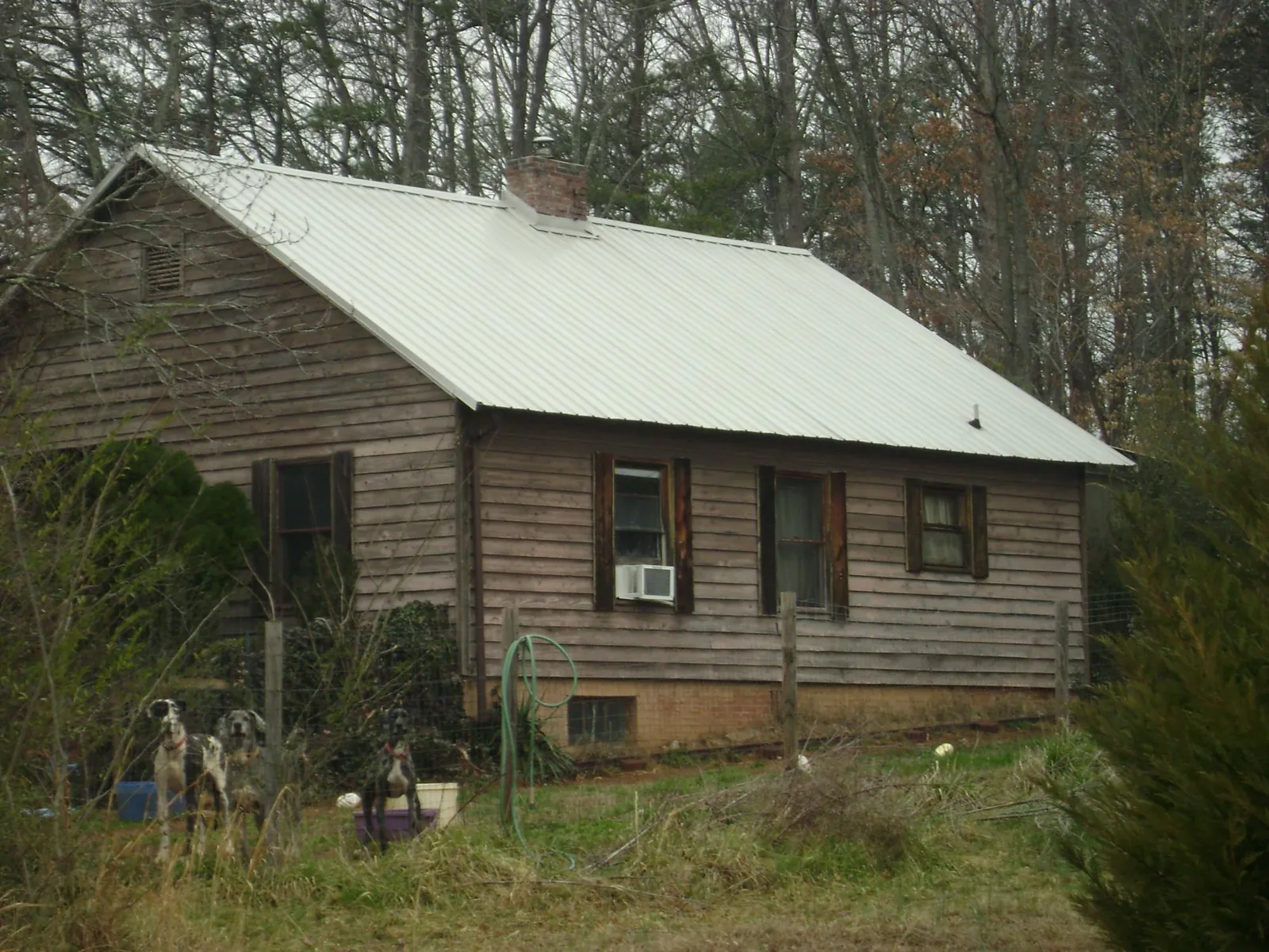 White metal roof on an old wood sided farmhouse, from a Metal Roof Installation job in Dell